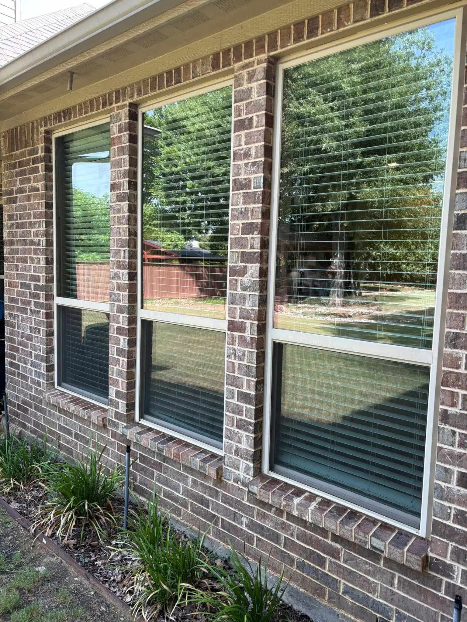 Brick home exterior — sparkling clean windows after professional service